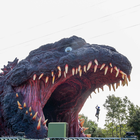 A person on the Godzilla zipline at the Godzilla theme park area in Nijigen no Mori