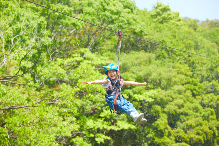 Child flying on Action Mask zipline at Crayon Shin-chan Adventure Park in Nijigen no Mori Awaji Island
