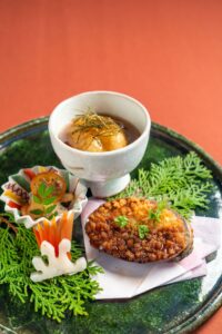 Japanese simmered dish served in ceramic bowl with seasonal vegetables and delicate garnish at a Japanese soba restaurant