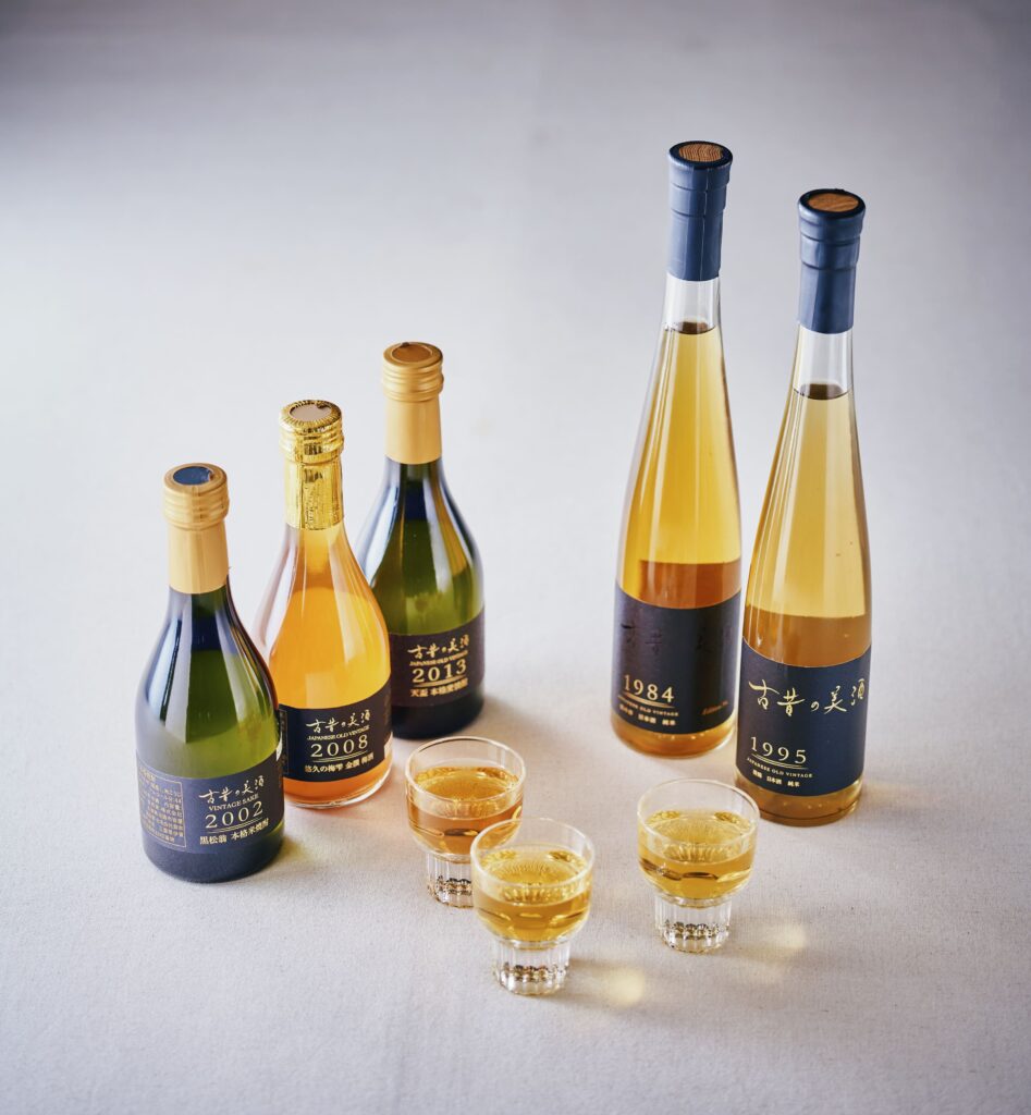 Selection of vintage Japanese sake bottles with tasting glasses