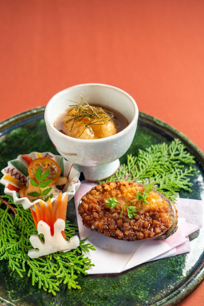 Japanese simmered dish served in ceramic bowl with seasonal vegetables and delicate garnish