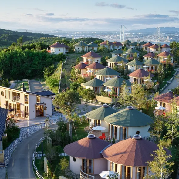 Overhead shot of GRAND CHARIOT. Round cocoon-like private villas are laid out on a hill.