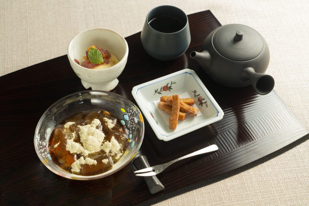 Traditional Japanese dessert assortment with tea, wagashi, and seasonal sweets