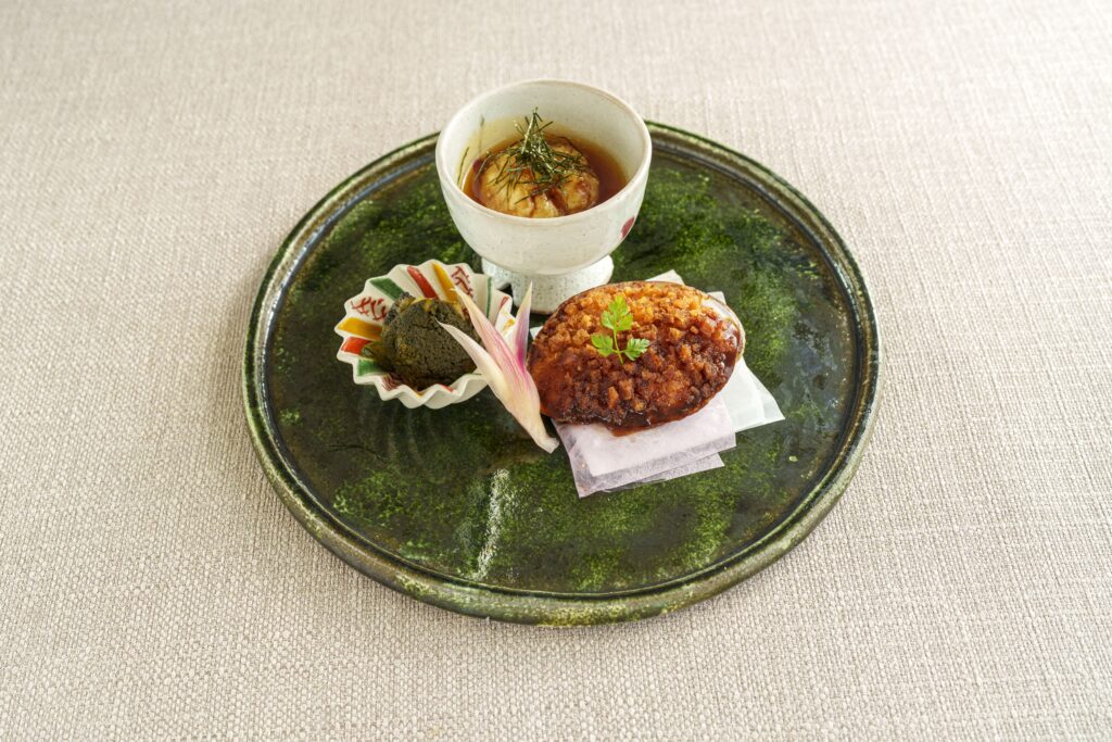 Traditional Japanese appetizer plate with chawanmushi and seasonal garnish