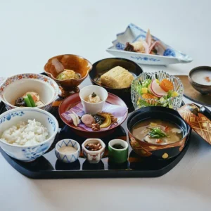 Beautifully arranged Japanese breakfast with rice, miso soup, side dishes, tamagoyaki, tofu, and seasonal vegetables at a luxury ryokan on Awaji Island.