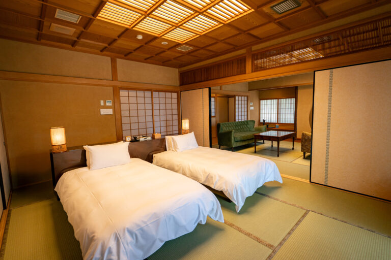 Traditional Japanese inn bedroom in luxury ryokan Awaji Island with semi-double beds, tatami mats and private onsen suite for family retreat in Luxury Japanese Ryokan with Private Onsen on Awaji Island