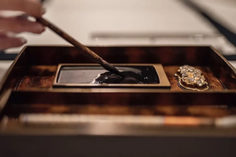 Traditional Japanese calligraphy brush and inkstone used during a mindfulness session at an Awaji Island Wellness & Zen Retreat