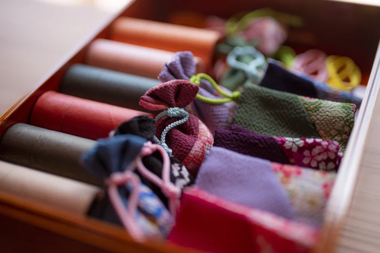 Beautifully packaged aroma oils and handcrafted pouches used for relaxation rituals at an Awaji Island Wellness & Zen Retreat
