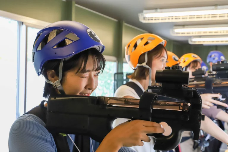 Visitors playing Godzilla shooting attraction game at Nijigen no Mori Awajishima