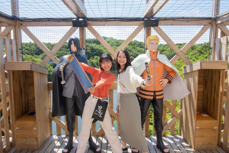Visitors posing like ninjas with Naruto statue at Nijigen no Mori on Awaji Island